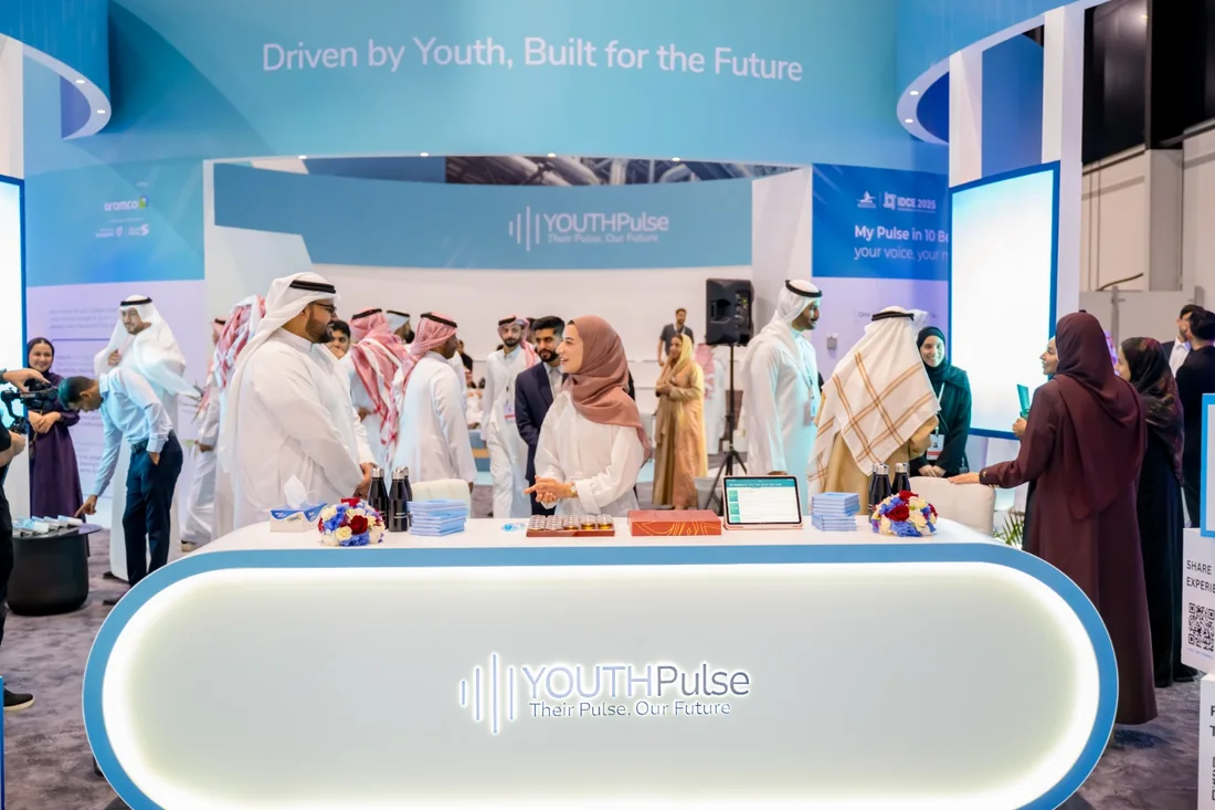 The Youth Pulse stand at IDCE 2025, with participants meeting at the welcome desk